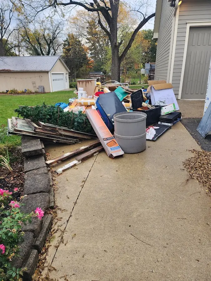 Dumpster being loaded with debris for 3 Yard Dumpster Rental in New Boston